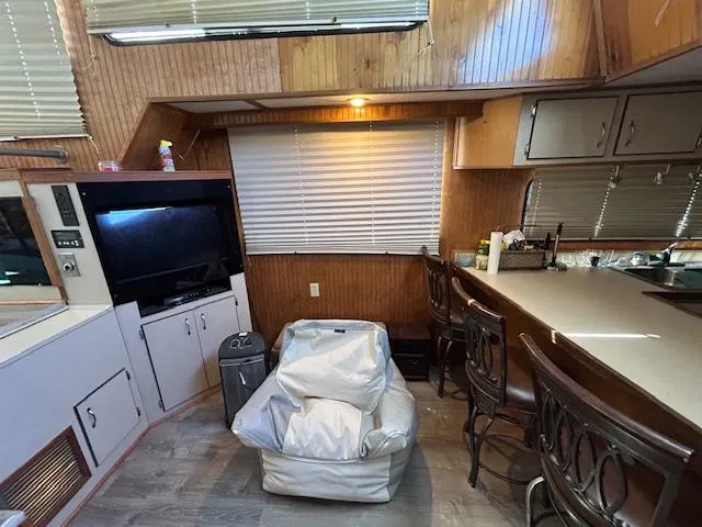 Slide: The Image of Interior of a 1995 Gibson 5500 SERIES boat with seating, TV, and kitchen area. - 14