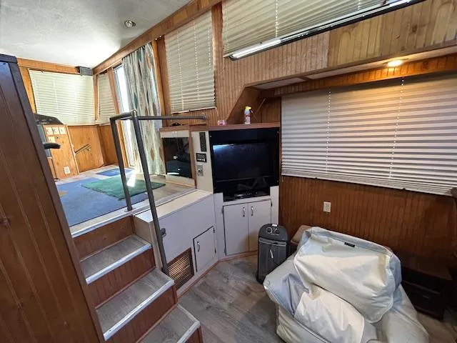 Slide: The Image of Interior of a 1995 Gibson 5500 SERIES boat with wood paneling and modern amenities. - 15