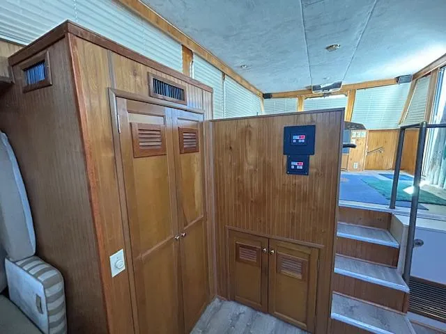 Slide: The Image of Interior of a 1995 Gibson 5500 SERIES boat with wooden cabinetry and stairs. - 19