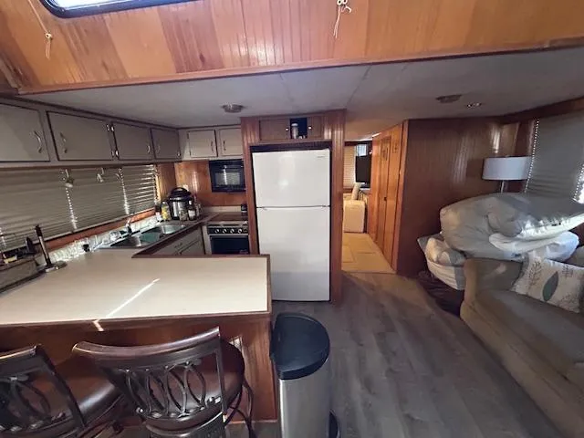 Slide: The Image of Interior of a 1995 Gibson 5500 SERIES houseboat with kitchen and living area. - 22