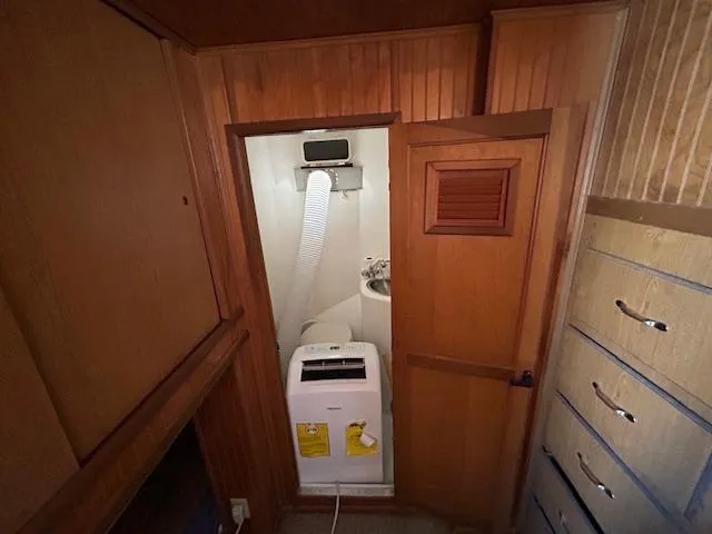 Slide: The Image of Compact laundry area with a Gibson 5500 SERIES washing machine, wooden cabinetry, and ventilation hose. - 30