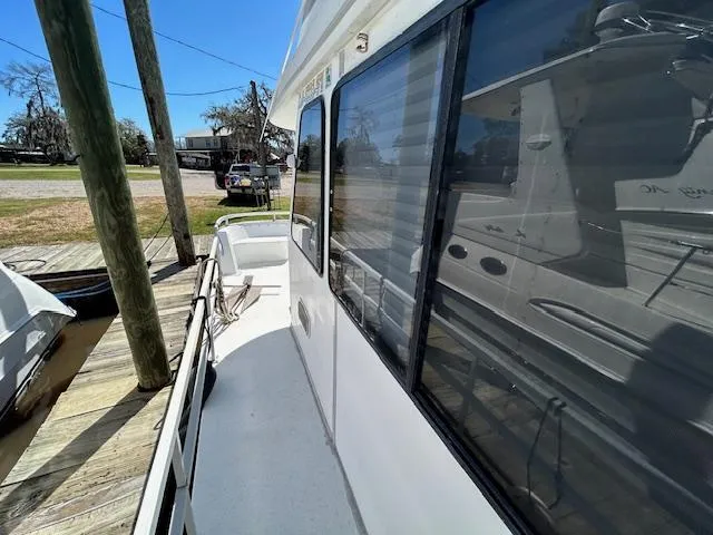 Slide: The Image of 1995 Gibson 5500 SERIES boat docked, side view with windows and railing. - 36