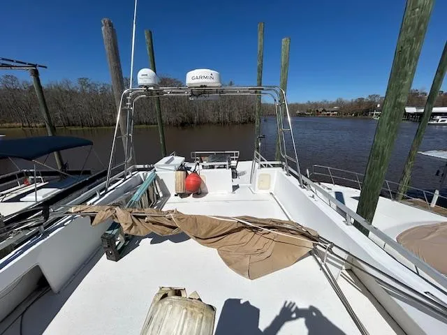 Slide: The Image of Gibson 5500 SERIES boat deck, 1995 model, docked by a river under clear blue sky. - 38