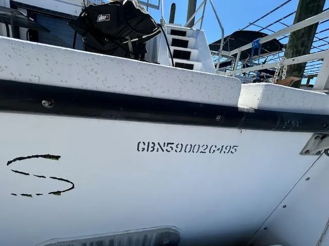Slide: The Image of Gibson 5500 SERIES boat, 1995 model, docked with visible hull identification number. - 46