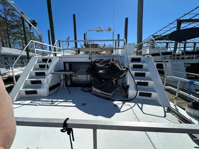 Slide: The Image of Gibson 5500 SERIES 1995 boat deck with stairs and equipment under clear blue sky. - 47