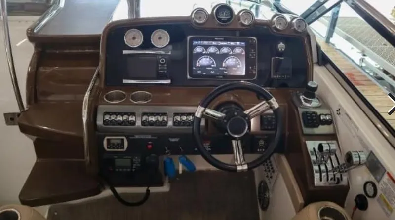 Slide: The Image of 2016 Formula 400 Super Sport boat dashboard with steering wheel and control panel. - 16