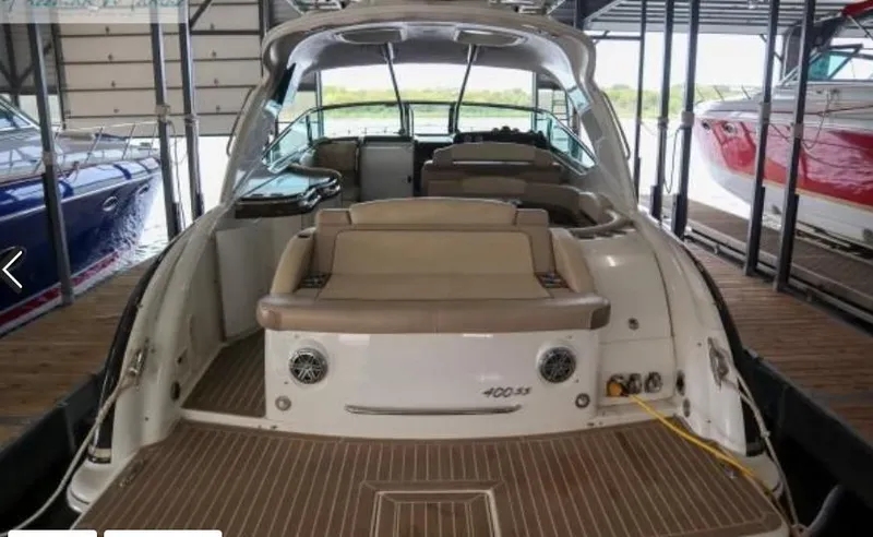 Slide: The Image of 2016 Formula 400 Super Sport boat docked in a marina, showcasing sleek design and spacious seating. - 5