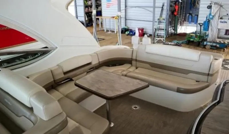 Slide: The Image of 2016 Formula 400 Super Sport yacht interior with beige seating and table in a marina setting. - 9