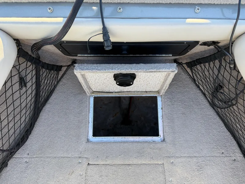 Slide: The Image of Interior view of a 2001 Lund 1950 Tyee Magnum GS ITS boat, featuring storage compartments. - 13