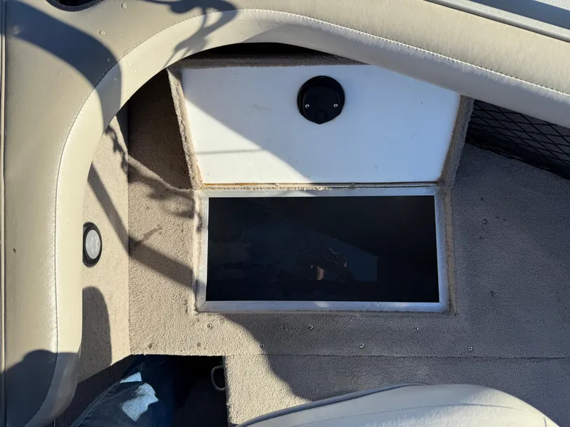 Slide: The Image of Interior of 2001 Lund 1950 Tyee Magnum GS ITS boat, featuring storage compartment. - 14