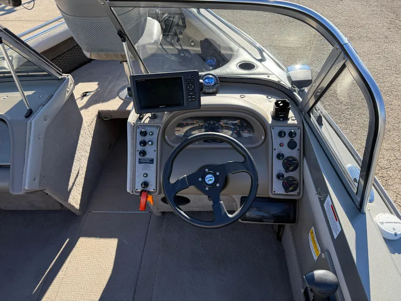 Slide: The Image of 2001 Lund 1950 Tyee Magnum GS ITS boat dashboard with steering wheel and navigation equipment. - 20