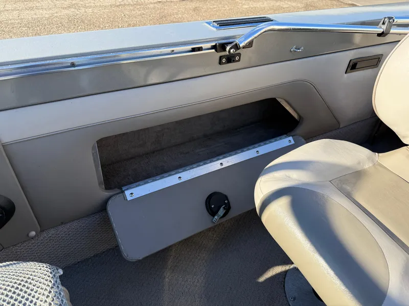 Slide: The Image of Interior of a 2001 Lund 1950 Tyee Magnum GS ITS boat, featuring storage compartment and seating. - 28