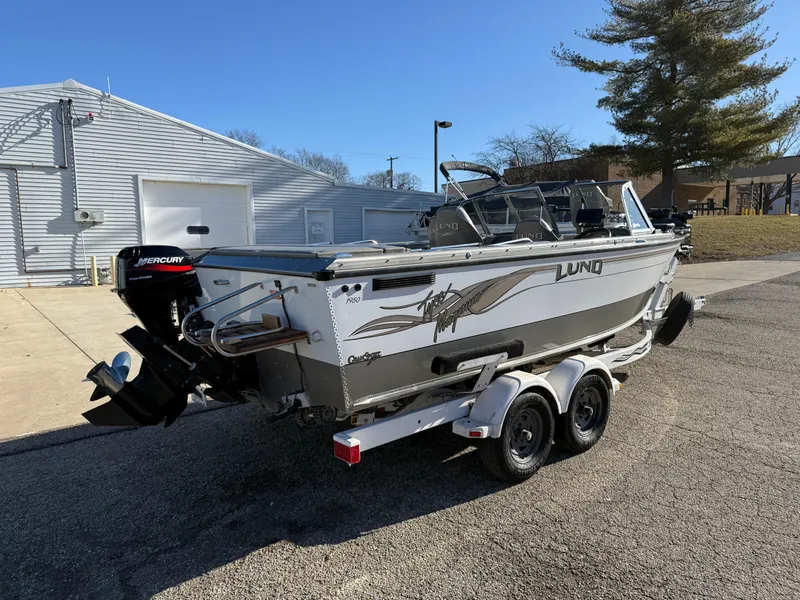 Slide: The Image of 2001 Lund 1950 Tyee Magnum GS ITS boat on trailer, parked outdoors. - 4