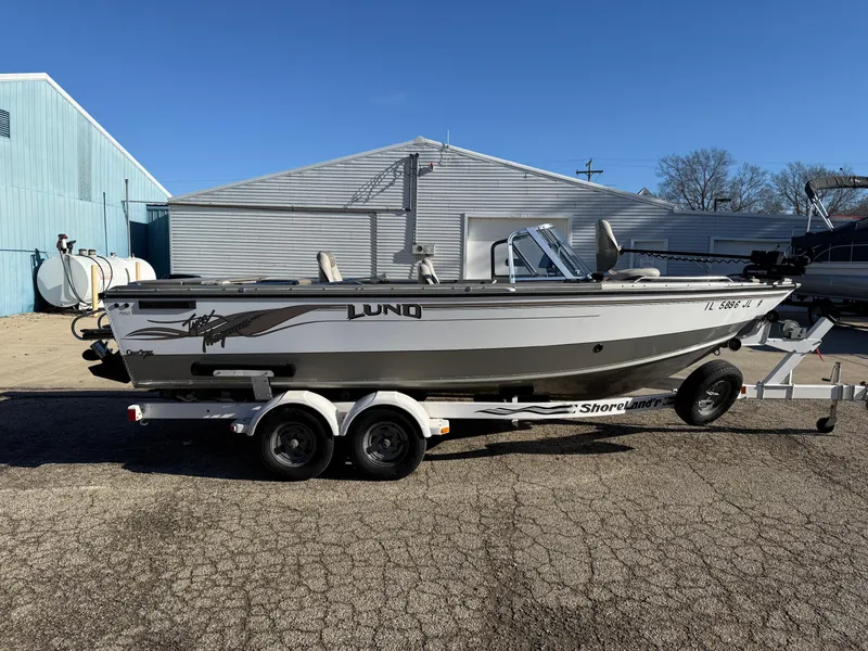 Slide: The Image of 2001 Lund 1950 Tyee Magnum GS ITS boat on trailer, parked outdoors. - 5