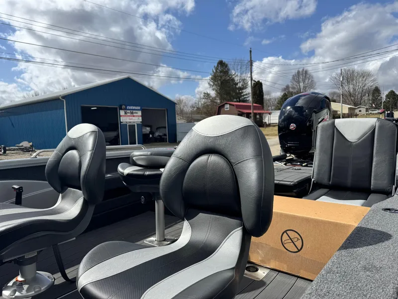 Slide: The Image of 2025 Vexus ADX190 boat interior with black seats, outdoor setting, and blue sky. - 8