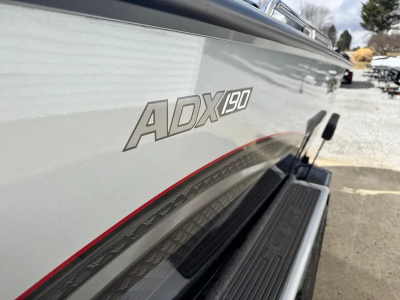Slide: The Image of 2025 Vexus ADX190 boat side view with logo, showcasing sleek design and detailing. - 9