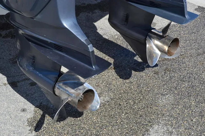 Slide: The Image of Twin outboard motors of a 2006 Clearwater 2500 WI CC boat on a concrete surface. - 5