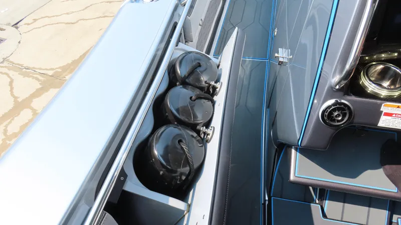 Slide: The Image of 2022 MTI 50v boat with black fenders stored on deck. - 11