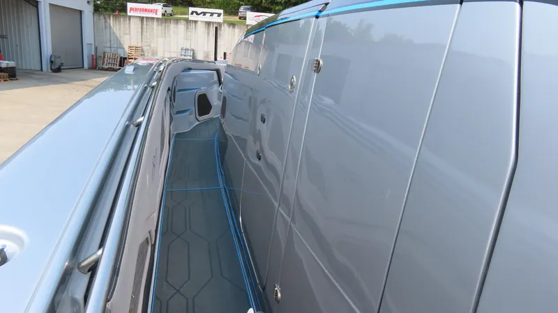 Slide: The Image of 2022 MTI 50v boat side view, showcasing sleek design and modern detailing. - 12
