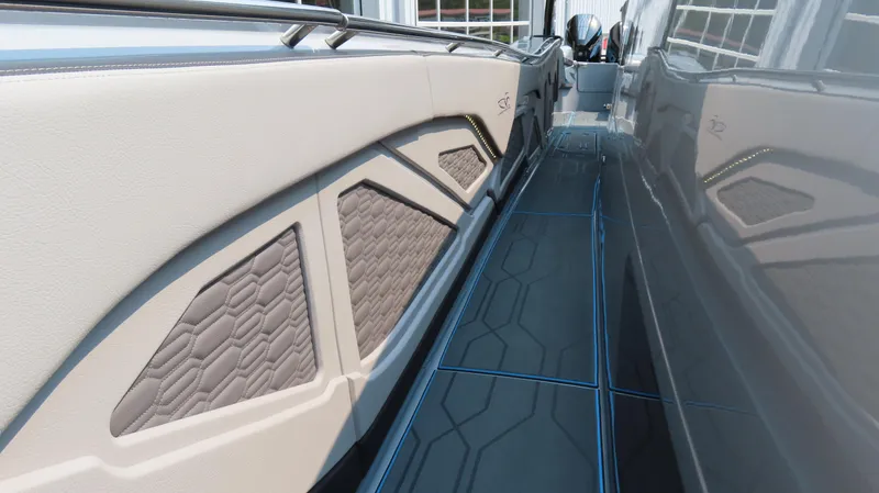 Slide: The Image of 2022 MTI 50v boat interior with hexagonal pattern and sleek design. - 28