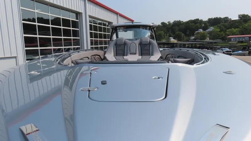 Slide: The Image of 2022 MTI 50v boat with sleek silver design, docked near a modern building. - 4