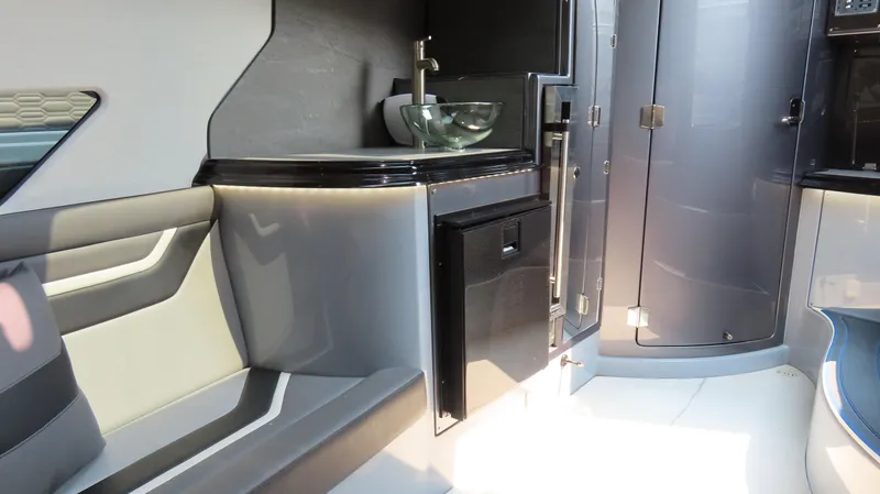 Slide: The Image of Modern MTI 50v 2022 boat interior with sleek design, featuring a compact sink and seating area. - 45