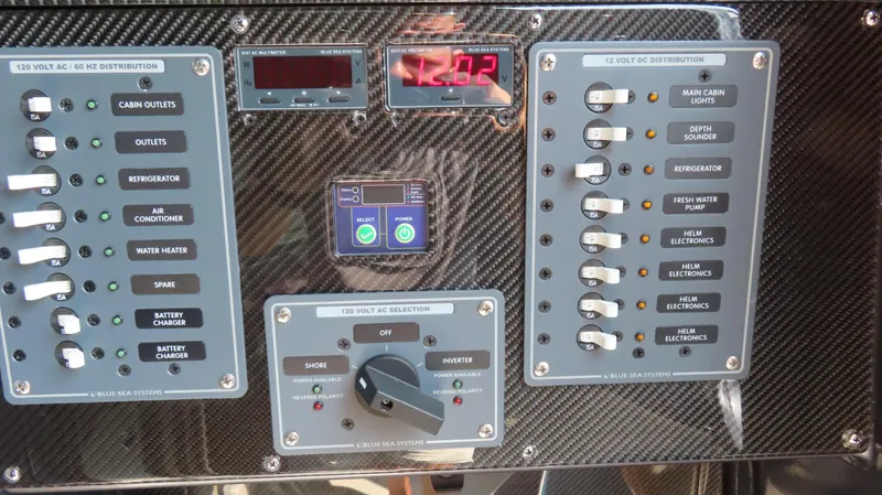 Slide: The Image of Control panel of a 2022 MTI 50v boat with switches and digital displays. - 46