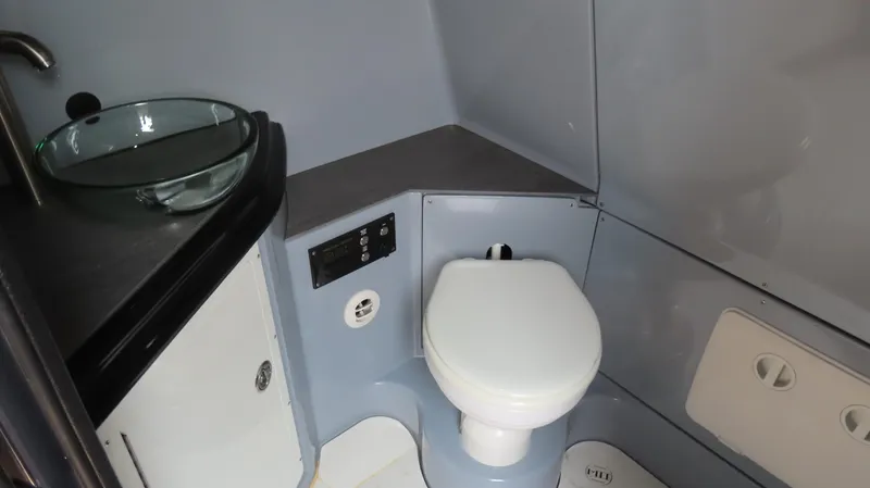 Slide: The Image of Compact modern bathroom in MTI 50v 2022 model, featuring a glass sink and toilet. - 48