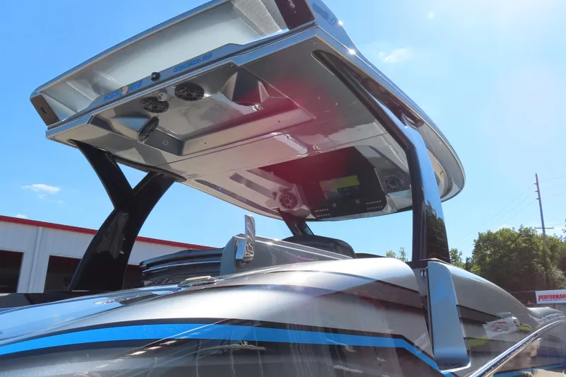 Slide: The Image of 2022 MTI 50v boat with sleek design and advanced features under a clear blue sky. - 50