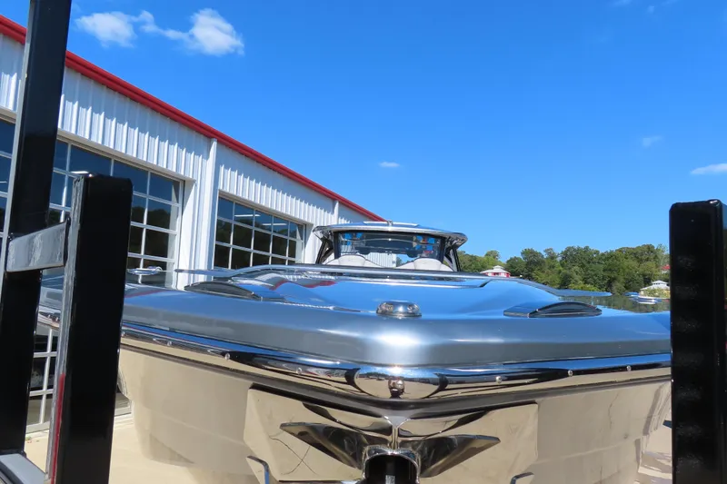 Slide: The Image of 2022 MTI 50v boat docked near a modern building under a clear blue sky. - 51