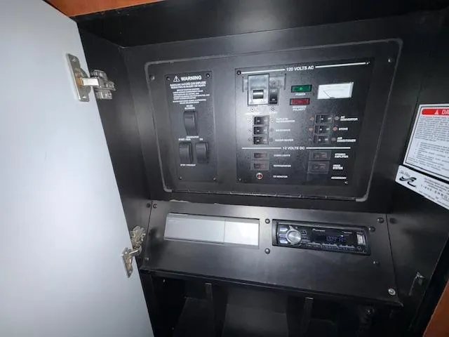 Slide: The Image of Electrical control panel inside 2003 Sea Ray 280 Sundancer boat. - 18