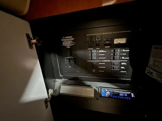 Slide: The Image of Electrical control panel inside 2003 Sea Ray 280 Sundancer boat cabin. - 19