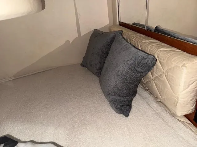 Slide: The Image of Interior cabin of 2003 Sea Ray 280 Sundancer with cozy bedding and pillows. - 20
