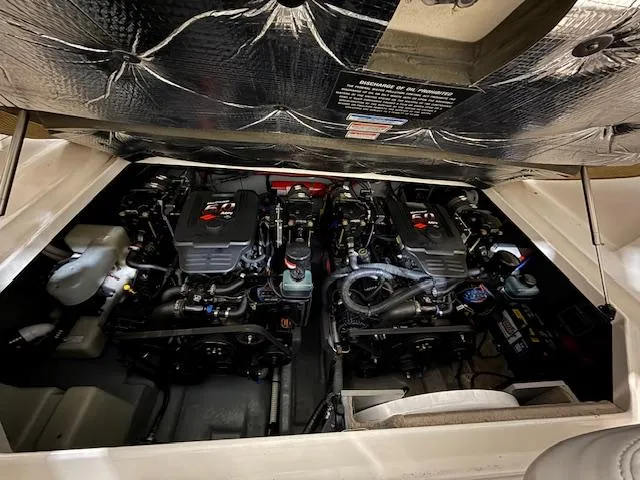 Slide: The Image of Engine compartment of a 2003 Sea Ray 280 Sundancer, showcasing dual engines and components. - 22