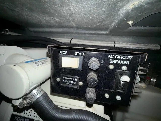 Slide: The Image of Control panel of a 2003 Sea Ray 280 Sundancer boat with AC circuit breaker. - 24