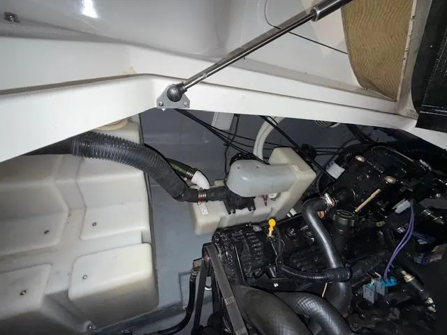 Slide: The Image of Engine compartment of a 2003 Sea Ray 280 Sundancer boat, showing hoses and components. - 25