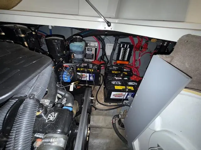 Slide: The Image of Engine compartment of 2003 Sea Ray 280 Sundancer with visible batteries and wiring. - 26