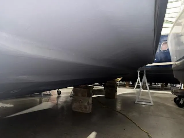Slide: The Image of 2003 Sea Ray 280 Sundancer boat hull on supports in storage facility. - 27