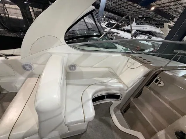 Slide: The Image of 2003 Sea Ray 280 Sundancer interior with white seating and modern design. - 6
