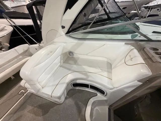 Slide: The Image of 2003 Sea Ray 280 Sundancer interior seating area with white upholstery. - 7