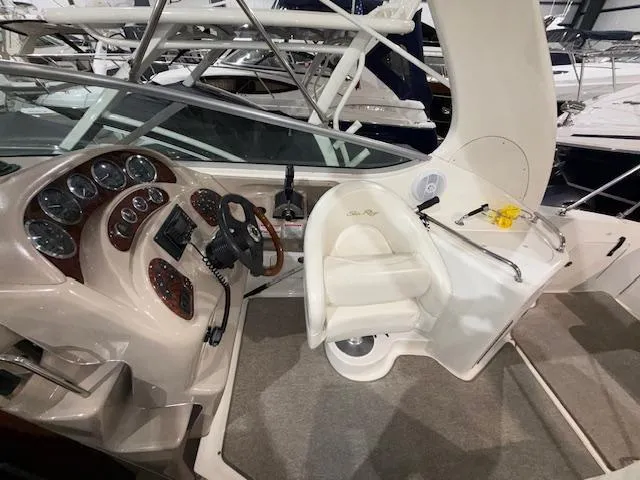 Slide: The Image of 2003 Sea Ray 280 Sundancer helm with steering wheel, gauges, and seating. - 8