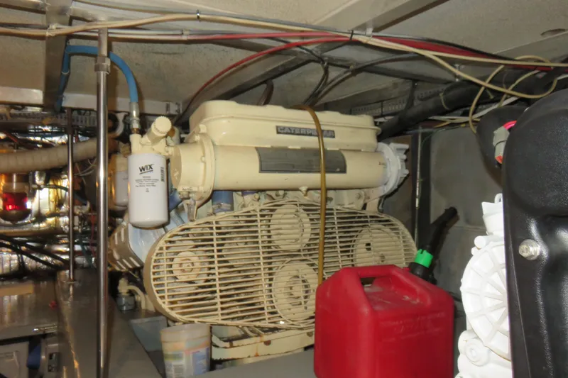 Slide: The Image of Engine room of 1988 Carver 42 Aft Cabin Motor Yacht with visible machinery and wiring. - 103