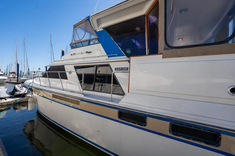Slide: The Image of 1988 Carver 42 Aft Cabin Motoryacht docked at marina, side view. - 11