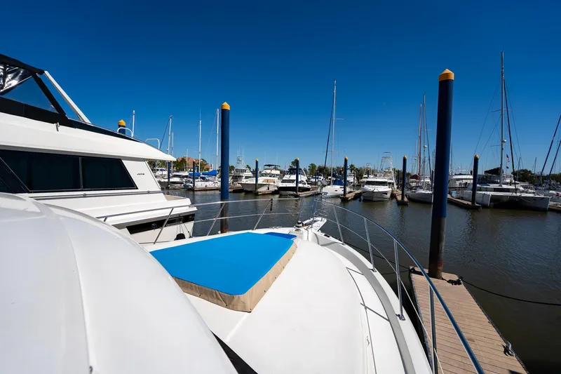 Slide: The Image of 1988 Carver 42 Aft Cabin Motoryacht docked in a marina under clear blue skies. - 17