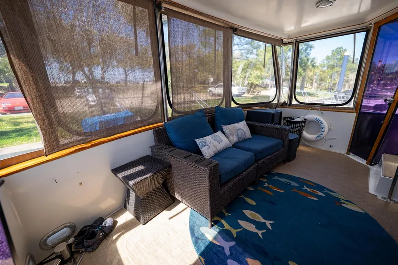 Slide: The Image of 1988 Carver 42 Aft Cabin Motoryacht interior with cozy seating and decorative rug. - 23