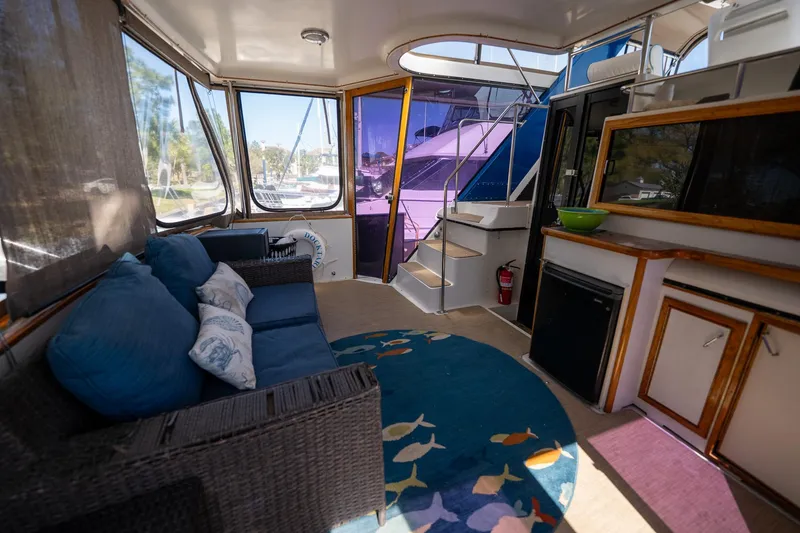 Slide: The Image of Interior of 1988 Carver 42 Aft Cabin Motoryacht with cozy seating and nautical decor. - 28