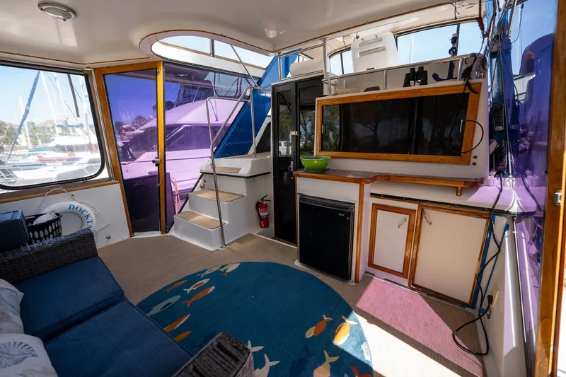 Slide: The Image of Interior of 1988 Carver 42 Aft Cabin Motoryacht with seating, kitchenette, and nautical decor. - 30