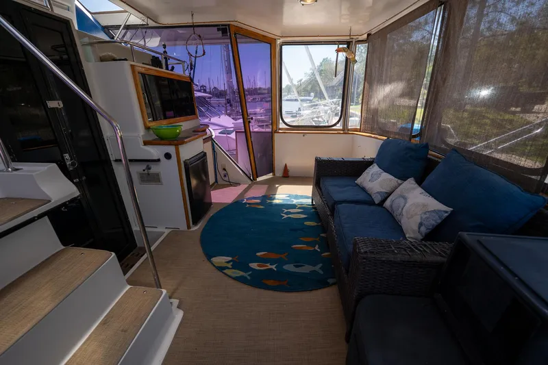 Slide: The Image of Interior of 1988 Carver 42 Aft Cabin Motoryacht with cozy seating and nautical decor. - 32