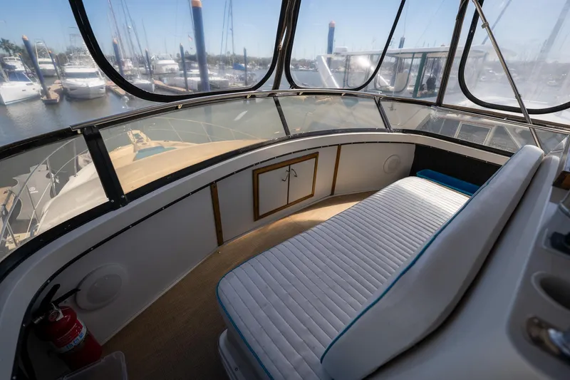 Slide: The Image of 1988 Carver 42 Aft Cabin Motoryacht interior with seating, docked at marina. - 43