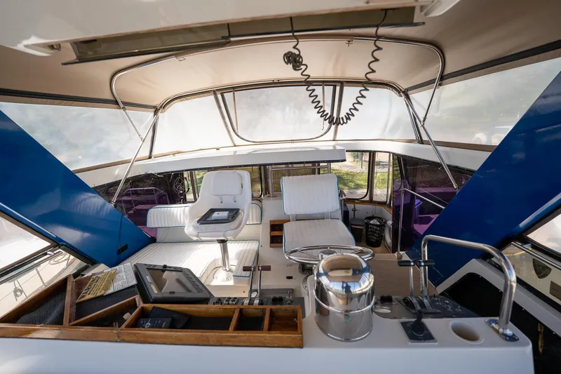 Slide: The Image of 1988 Carver 42 Aft Cabin Motoryacht interior with helm and seating area. - 46